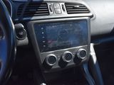 the dashboard of a car with a digital display in the center of it