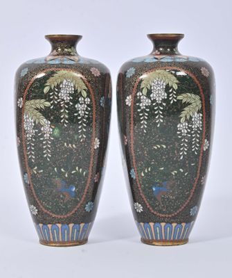 two vases sitting side by side on a white surface