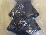 a pile of black plastic bags sitting on a wooden table