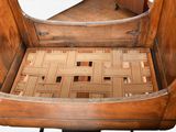 a wooden chair that has a seat made of wood