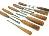 several different types of woodworking tools are lined up on a white surface