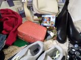 a pile of shoes, a purse, a handbag, and a pair of shoes