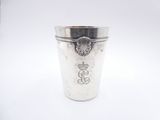a silver cup with a crown on it on a white surface