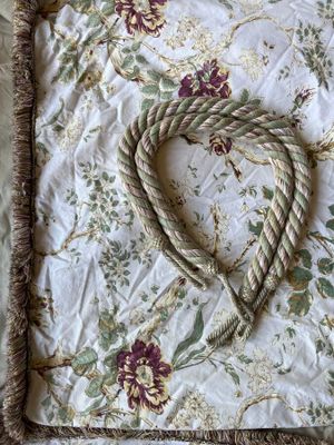 a heart made out of a rope on a bed