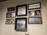 pictures on the wall of a clothing store with hangers