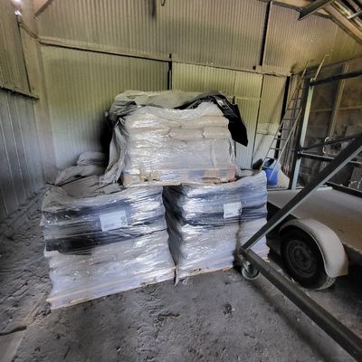 une grande pile de cartons et de sacs dans un entrepôt
