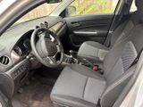 the interior of a small car with a steering wheel and dashboard