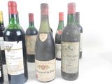 several bottles of wine sitting next to each other on a white surface