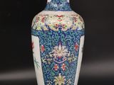 a blue and white vase sitting on a table next to a lamp