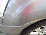 a close up of a car that has a denting on it