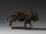 bronze statue of a bull on a wooden base on a gray background