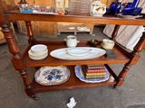 a wooden table with plates and bowls on it