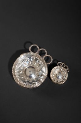 a close up of a silver object on a black surface