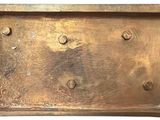 a picture of a metal box with rivets and screws