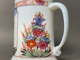 a white coffee mug with a floral design on it