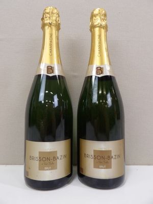 two bottles of champagne sitting next to each other on a table