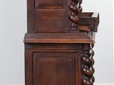 a wooden cabinet with a door on top of it