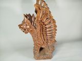 carved wooden statue of a dragon with wings on a white background