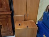 a wooden cabinet and a blue box in a room