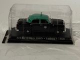 a black and green toy truck in a clear case