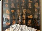 a painting of a man laying on a bed in front of a picture