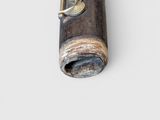 a close up of a small musical instrument on a white surface