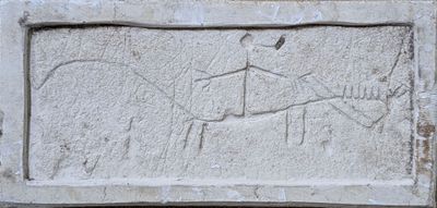 relief of a man riding a horse with a bird on its back