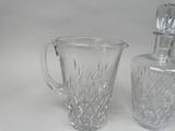 two glass vases sitting next to each other on a table