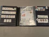two folders with stamps on them sitting on a table