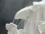 a white crocheted veil with flowers on it