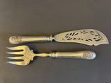pair of silver plated utensils on a black surface