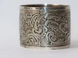 a close up of a silver ring on a white surface