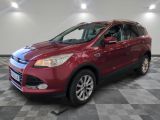 a red ford escape is parked in a large room