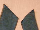 two pieces of cloth on a table with a pair of scissors