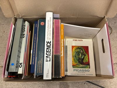 many books in a box on the floor