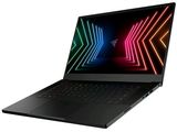 l'ordinateur portable est ouvert sur une surface blanche, avec des lumières colorées à l'écran