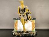 a statue of a woman and a child sitting on a bench