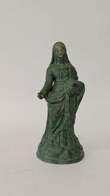 a green statue of a woman sitting on a chair