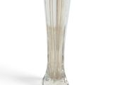 a glass vase that is sitting on a white surface