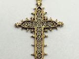 a gold cross pendant on a white background