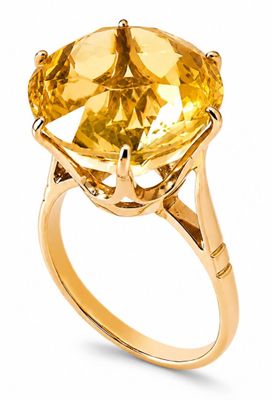a close up of a ring with a large citrine stone