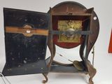 an old clock that is sitting on a stand