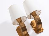 pair of brass table lamps with white shades on a white background