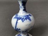un vase bleu et blanc posé sur une table