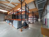 a large warehouse filled with lots of shelves and pallets
