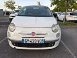 a small white car parked in a parking lot