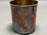 a silver cup with a red and blue design on it