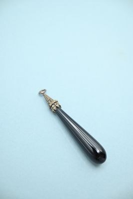 an image of a long black stone pendant on a white background