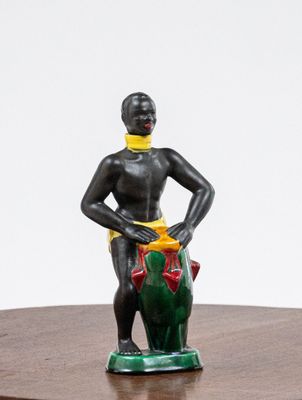 a figurine of a woman standing on a wooden table