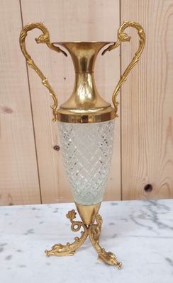 a gold vase sitting on top of a marble table